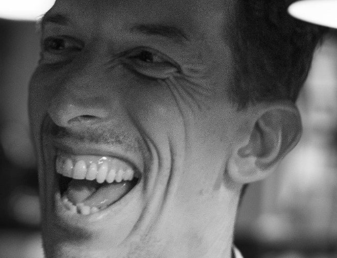 A chef laughing in the kitchen