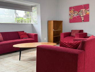 Communal lounge with red sofas in the Swiss Chalet